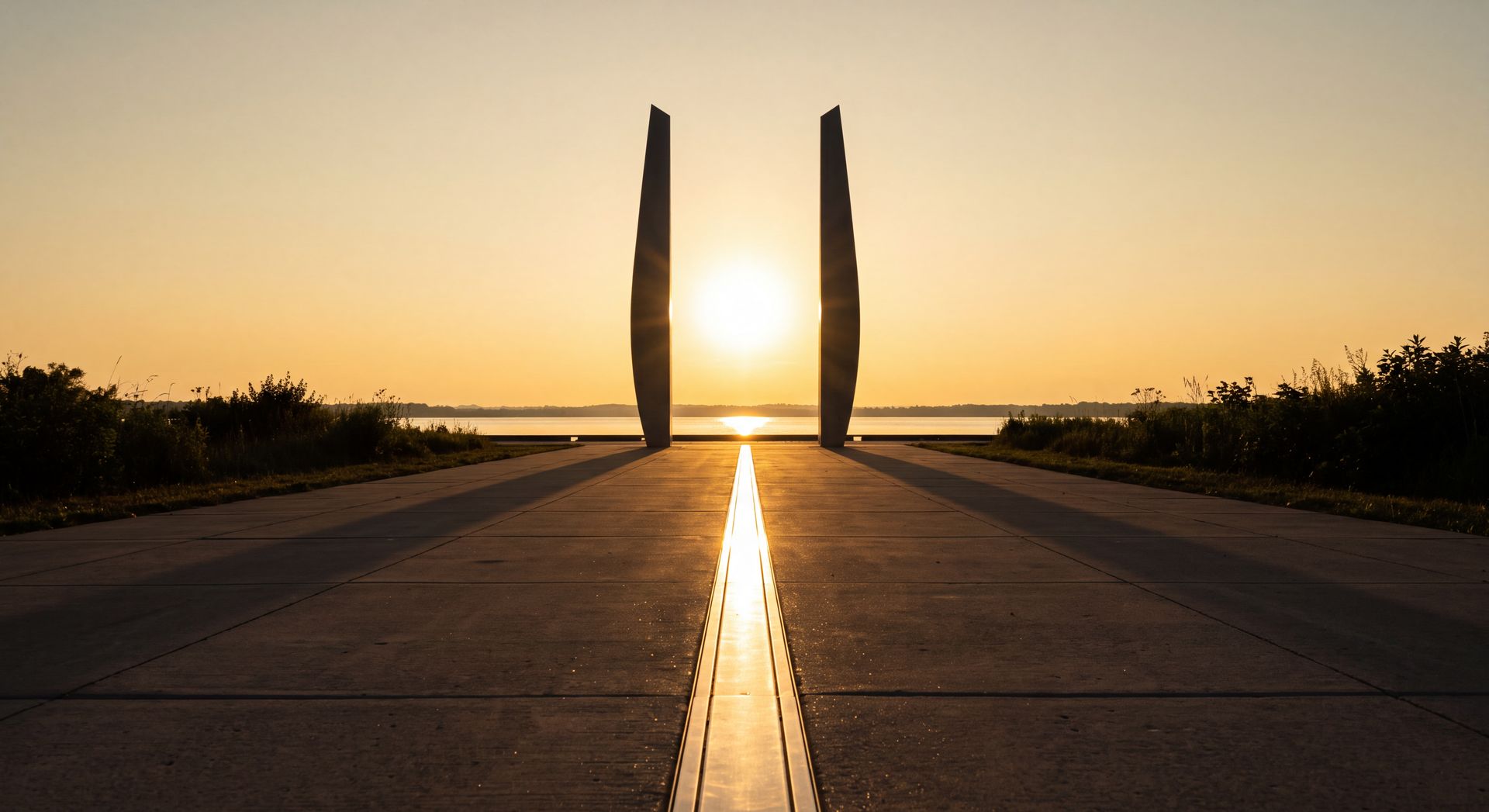 Concept rendering: the sun setting between two tall blades at the end of an inlaid stainless line on the greenway